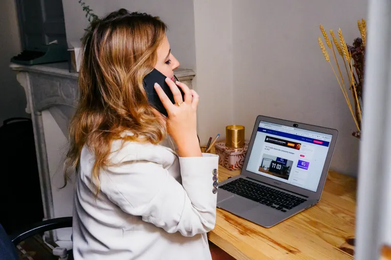 Une professionnelle au téléphone devant son ordinateur